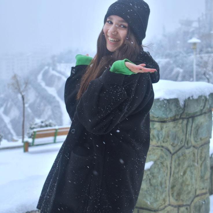 Kaveri Mehta, Lead Design Curator at Roam Petal Oak, reviewing corporate floral arrangements